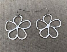 Unique, stylish and cool mod flower earrings.  They are simple and refined but also chic and fun.  These earrings are timeless and perfect for everyday wear.The earrings measure 1 3/8” long by 1 3/8” wide and are made from plated silver.  They hang from simple silver ear wire hooks.  Overall drop length is 1 1/2”.I have a matching necklace in my shop, if you would like the whole set.  Here is a direct link............Thanks for stopping by!  Please take a moment and visit the rest of my Etsy sto Trendy Silver Flower Earrings, Modern Metal Earrings For Spring, Spring Flower Shaped Nickel Free Earrings, Spring Flower-shaped Nickel-free Earrings, Trendy Nickel-free Flower Earrings, Everyday Flower Earrings For Spring, Spring Everyday Flower Shaped Earrings, Modern Spring Earrings For Gift, Everyday Flower Earrings With Spring Charm