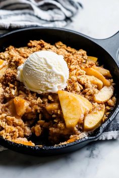 a skillet filled with apple crisp and ice cream