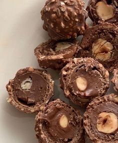 chocolate desserts with nuts in the middle on a white plate