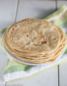 a stack of flat bread on a white plate