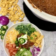 two bowls filled with different types of food next to a casserole dish on a table