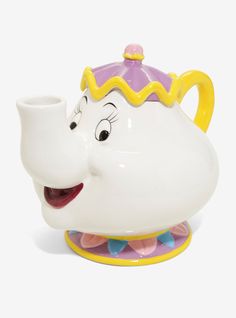 the beauty and the beast teapot has a smile on it's face