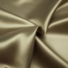 a close up view of a shiny gold fabric material that is very soft and smooth