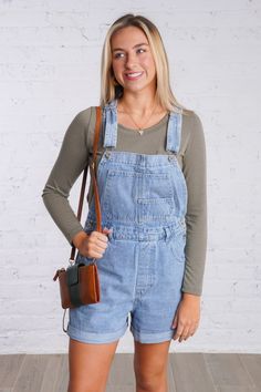 Get ready for a playful weekend with our Ramona Overalls. These cuffed denim overall shorts are in a light wash denim color and are perfect for a casual look. With adjustable straps and multiple pockets, these overalls have both style and functionality. They feature five pockets on the front and two on the back, button closures on each side, belts loops, and adjustable and removable straps. Don't miss out on these fun and versatile overalls! They are lightweight and fit true to size. 100% Cotton Model is 5'6" and is wearing a small Spring Medium Wash Overalls With Adjustable Straps, Medium Wash Denim Overalls With Adjustable Straps, Casual Medium Wash Shortalls With Pockets, Casual Light Wash Shortalls, Denim Overalls For Summer, Medium Wash Summer Overalls For Everyday, Everyday Summer Denim Overalls, Summer Everyday Medium Wash Overalls, Everyday Summer Medium Wash Overalls