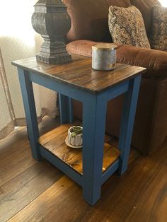 a table with a dog bowl on it in front of a couch