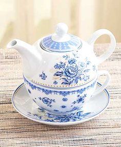 a blue and white tea set on a table