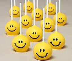 there are many smiley faces on the lollipops that have been placed together