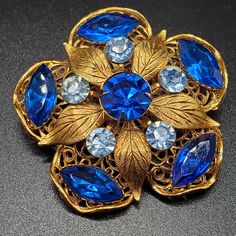 Beautiful Vintage 3D Brooch Pin, Blue Rhinestones, Gold Tone Filigree, Statement Piece Costume Jewelry Blue Brooches With Rhinestones, Elegant Blue Jeweled Brooches, Vintage Brooch Jewelry, Vintage Gold-tone Brooches For Formal Occasions, Luxury Gold Multi-stone Brooches, Luxury Ornate Gemstone Brooches, Gold Flower-shaped Brooches With Rhinestones, Vintage Gold-tone Jewelry Brooch, Vintage Rhinestone Brooch