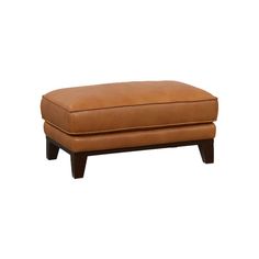 a brown ottoman sitting on top of a white floor