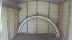 the inside of a shed with three arched doors