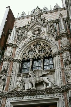 an ornate building with a statue of a lion on the front