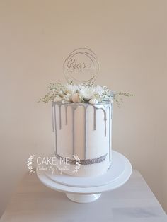 a white cake with frosting and flowers on top