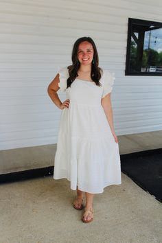 Featuring a square neck, short ruffled sleeves with smocking detail, a tiered silhouette and a textured fabric, this adorable white dress is a must have for summer! Color: White Square neck Short ruffled sleeves with smocking detail Tiered silhouette Midi Length Lined Model is 5'1 and wearing a small. See size guide in images for more details. Measurements are approximate. White Tiered Ruffle Dress For Summer, White Midi-length Tiered Dress For Garden Party, White Midi Length Tiered Dress For Garden Party, White Midi Tiered Dress For Garden Party, White Tiered Ruffle Dress For Garden Party, White Ruffled Tiered Dress For Garden Party, White Ruffle Hem Tiered Dress For Vacation, White Midi Tiered Dress With Ruffle Hem, White Tiered Dress With Ruffle Hem For Vacation