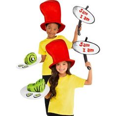 two children in costumes holding up signs with the same name on them and one child wearing a red hat