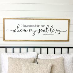 a bed with pillows and a sign above it that says i have found the one whom my soul loves