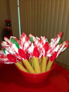 a red bowl filled with pasta and candy canes