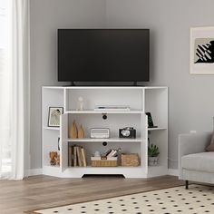 a flat screen tv mounted to the side of a white bookcase in a living room