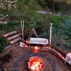 an outdoor hot tub sitting next to a fire pit