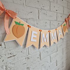 an orange and white banner with the word'emma'hanging on a brick wall