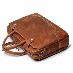 Elevate your professional game with The Everyday Briefcase, a sleek and timeless companion designed for daily office use. Crafted from genuine buffalo leather, this full-grain marvel seamlessly blends classic aesthetics with a modern touch. With its robust construction, it's not just a briefcase; it's a lasting investment. The Everyday Briefcase boasts two side pockets, an interior laptop compartment with a zipper pocket, and features durable brass hardware, YKK zippers, and runners. Customize y Laptop Bag Men, Genuine Leather Totes, Leather Laptop Bag, Briefcase For Men, Leather Handbags Tote, Leather Laptop, Messenger Bag Men, Buffalo Leather, Leather Briefcase