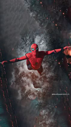 a spider man flying through the air with his arms out in front of fire and water