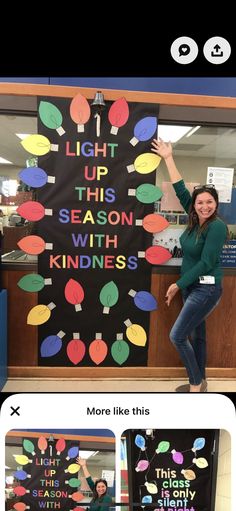 a woman standing in front of a sign that says light up this season with kindness