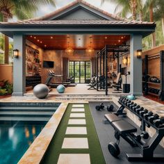 a home gym with an indoor swimming pool and exercise equipment in the foreground, surrounded by palm trees