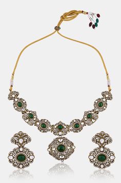 Inspired by the romantic Victorian era, this elegant necklace set is a true masterpiece. Encrusted with sparkling polki stones and adorned with cubic zirconia for added brilliance, it features emerald green stones that add a touch of color and allure. Accompanied by matching earrings, this set is the perfect choice for a formal occasion, exuding timeless charm and sophistication. Finish: Rhodium Plating Material: Silver, Copper Alloy, Emerald, Polki & CZs Color: Green Size: Free Size, Adjustable Hand Jewelry Rings, Chain Braid, Emerald Green Stone, Green Stones, Elegant Necklace, Hand Jewelry, Elegant Necklaces, Charm Set, Anklet Jewelry