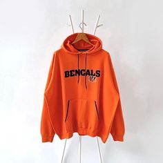 Vintage Cincinnati Bengals NFL hoodie/ XL * PLEASE READ BEFORE PURCHASE * PLEASE consider the PHOTOS before making the decision * The images may DIFFER in appearance from the actual product because we took pictures under daylight.  * PLEASE send your PHONE NUMBER after your purchase for the shipping company to contact you X No returns X No refund Condition : 8/10 More details : hole (cuff)/ look at the pictures  Brand : NFL Size : XL Pit to pit/ Chests : 29/58 inches  Length : 29.5 inches  Mater Orange Cotton Hoodie With Letter Print, Orange Letter Print Hoodie For Streetwear, Oversized Orange Hoodie For Streetwear, Orange Sweatshirt With Drawstring Hood For Streetwear, Orange Drawstring Hood Sweatshirt For Streetwear, Orange Hooded Sweatshirt With Letter Print, Orange Hooded Hoodie For Streetwear, Orange Fleece Hoodie For Streetwear, Orange Hooded Hoodie With Letter Print