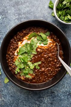 a bowl filled with beans and topped with cilantro