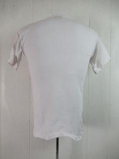 "Vintage 1980s vacation travel t shirt. Made of white cotton. has multi color graphics with sun, surf, palm trees and sailboat. Reads: Diamond Hotel and Resorts Playacar. Size medium. Actual measurements are: 35\" around the chest 35\" around the waist 18\" shoulder seam to shoulder seam 26.5\" overall length In very good condition with small spot on the back(photo)." Fitted Cotton T-shirt For Beach, Vintage White Summer T-shirt, Vintage White T-shirt For Summer, White Cotton Camp Shirt With Graphic Print, Cotton Graphic Tee Camp Shirt With Short Sleeves, White Pre-shrunk Short Sleeve Camp Shirt, Vintage Cotton Beach Tops, Vintage Relaxed Fit T-shirt For Beach, White Cotton Camp Shirt With Crew Neck