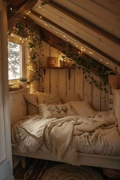 an attic bedroom is decorated with plants and string lights