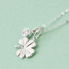 "Sterling Silver Four Leaf Clover w/ Sterling Silver Gemstone A whimsical sterling silver Four Leaf Clover, accented by a sterling silver Birthstone Charm. A perfect lucky charm to wear every day! We hand make these in our studio, then we attach a sterling jump ring to act as bail. The pendant includes a sterling silver curb chain. The Clover Charm is about 1/2 of an inch in length. You can choose the chain length - 16,18 or 20 inches. January - garnet cz (dark red) February - amethyst cz (purpl Lucky Charm Necklace, Four Leaf Clover Necklace, Wedding Pendant, Clover Charm, Clover Necklace, Four Leaves, Necklace Gemstone, Birthstone Charms, Four Leaf