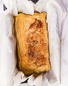 a piece of bread sitting in some white paper