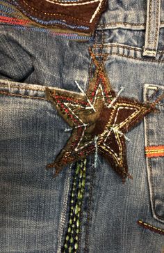 the back pocket of a pair of jeans with a star on it's side