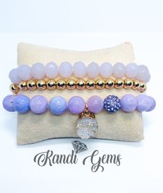 Handmade beautiful stack of 3 bracelets. Beautiful mixture of Light purple and Gold. Natural Purple Jade Chalcedony Gemstones, Crystal Glass Light Purple Beads and Gold Plated Hematite Beads.  Stretch bracelet set available in various sizes.  Materials 10mm Purple Jade Chalcedony Beads 10mm Faceted Lavender Glass Beads 6mm Gold Plated Hematite Beads   Standard Bracelet Sizing Small Wrist 6" - 7" Medium Wrist 7" - 8" Large Wrist 8" - 9" For custom bracelet requests, please measure your exact wris Bead Ball, Stacking Bracelets, Purple Jade, Ball Bracelet, Gold Bead Bracelets, Glass Beaded Bracelets, Metallic Blue, Purple Glass, Custom Bracelets