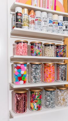 the shelves are filled with different types of confetti and sprinkles