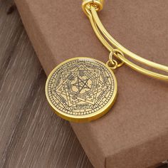 "This Seal of the True God Bracelet Is the Perfect Gift Whether for Yourself or a Loved One.  Explore all our Witchcraft jewelry here: https://www.etsy.com/in-en/shop/SymbolicPresent?ref=seller-platform-mcnav&section_id=22613465 ➜ Our jewelry is made of high-quality surgical steel with a shatterproof liquid glass coating and an 18k gold finish option. ➜ Engrave onto the back of the Sigillum Dei Aemeth pendant your loved one's name, your wedding date, an anniversary, or anything else you want to Spiritual Engraved Charm Bracelet Gift, Spiritual Engraved Charm Bracelet For Gift, Symbolic Etched Bangle Jewelry, Symbolic Engraved Charm Bracelet As Gift, Symbolic Engraved Charm Bracelet Gift, Symbolic Engraved Charm Bracelet For Gift, Spiritual Gold Pendant Bracelets, Spiritual Gold Pendant Bracelet, Gold Spiritual Pendant Bracelet