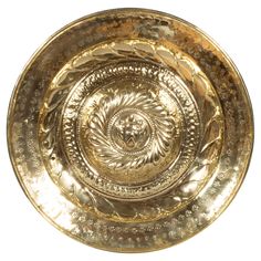 a gold plate with an intricate design on it