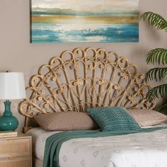 a bedroom scene with focus on the bed's headboard and nightstand, which has a painting hanging above it