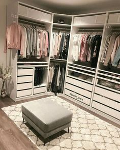 a walk in closet filled with lots of clothes and shoes on top of white drawers