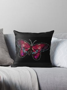 a pink butterfly on black throw pillow with the image of a pink butterfly on it's back