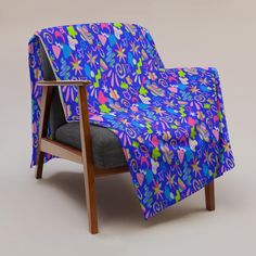 a chair with a blue and pink blanket on it