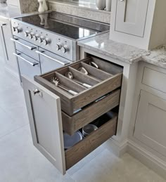 an open drawer in the middle of a kitchen