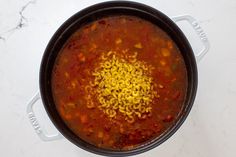 a pot filled with soup on top of a white counter