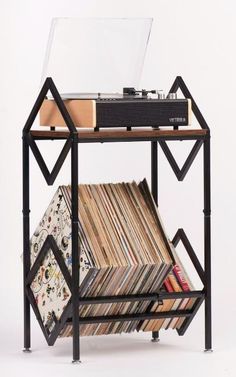 a record player is sitting on top of a shelf filled with records