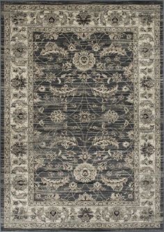 a rug with an ornate design on the front and back side, in grey tones