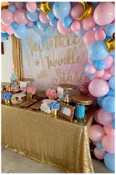 a table topped with balloons and cake