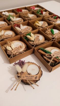 several small boxes with candles in them sitting on a table