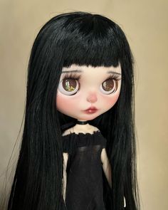 a doll with long black hair and brown eyes